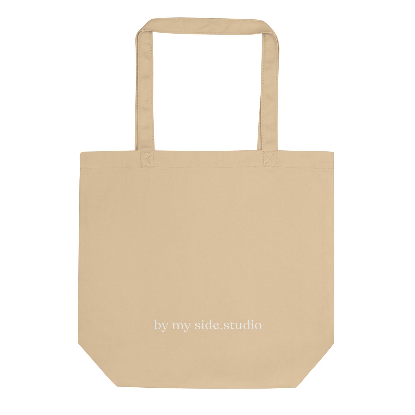 Beige tote bag with 'by my side.studio' text on a white background