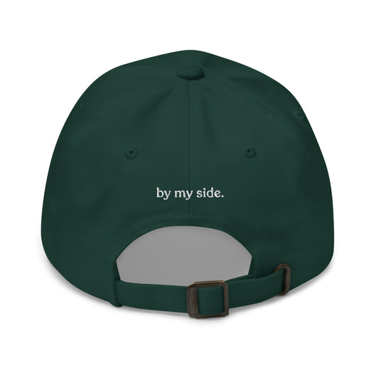Green cap with 'by my side.' text on a white background