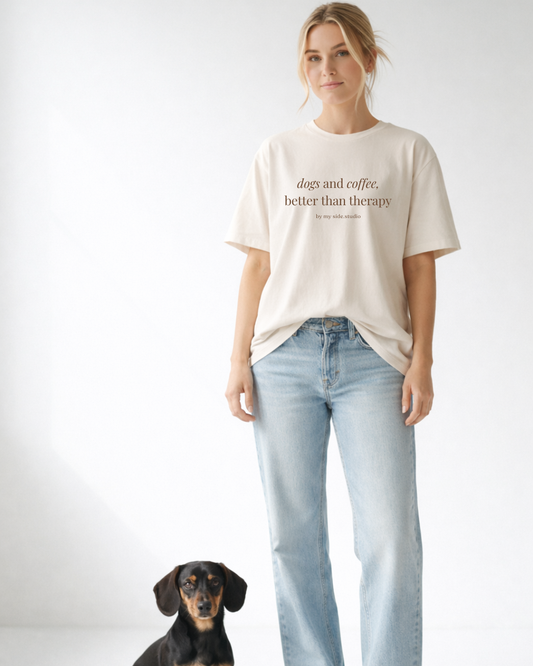 Woman wearing a t-shirt with text and light blue jeans, standing next to a dog on a white background