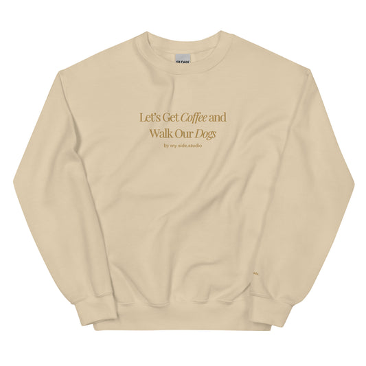Beige sweatshirt with text 'Let's Get Coffee and Walk Our Dogs' on a white background